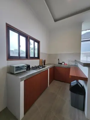 a kitchen with a sink and a counter with a microwave at Le Calme Villa Brand New 2 BR Private Villa near Seminyak in Kerobokan