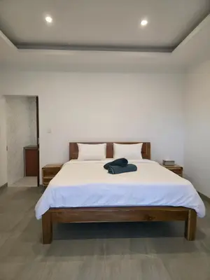a bedroom with a large white bed with white sheets at Le Calme Villa Brand New 2 BR Private Villa near Seminyak in Kerobokan
