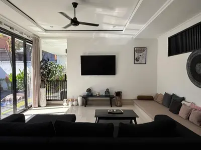 a living room with a couch and a flat screen tv at Homy 3 Bedrooms Villas in Canggu Umalas in Kerobokan
