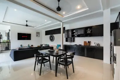 a kitchen and living room with a table and chairs at Homy 3 Bedrooms Villas in Canggu Umalas in Kerobokan