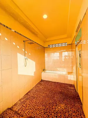 a bathroom with a shower and a bath tub at Dbelid Royal House - Private 5BR Villa in Jimbaran in Jimbaran