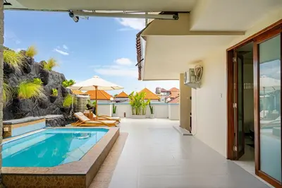 a swimming pool in the middle of a house at Dbelid Royal House - Private 5BR Villa in Jimbaran in Jimbaran