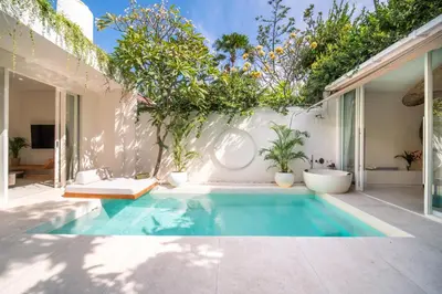 a swimming pool in the backyard of a house at Magic Day 2BR Private Sauna, Jacuzzi, Projector in Seminyak