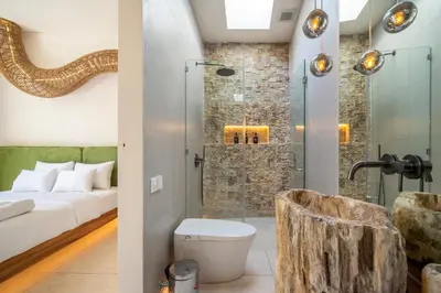 a bathroom with a bed and a shower with a toilet at Magic Day 2BR Private Sauna, Jacuzzi, Projector in Seminyak