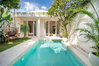 a swimming pool in the backyard of a house at Magic Day 2BR Private Sauna, Jacuzzi, Projector in Seminyak