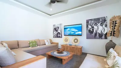 a living room with a couch and a table at Villa Alana, 3 BR Villa in Kerobokan in Mantaak