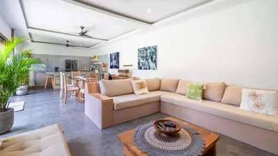 a living room with a couch and a table at Villa Alana, 3 BR Villa in Kerobokan in Mantaak