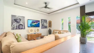 a living room with a couch and a ceiling fan at Villa Alana, 3 BR Villa in Kerobokan in Mantaak