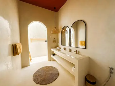 a bathroom with a sink and two mirrors at Villa Nabu - Serene Tropical Escape in Heart of Seminyak in Seminyak
