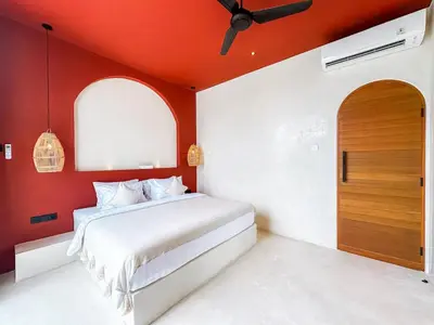 a bedroom with a bed with an orange ceiling at Villa Nabu - Serene Tropical Escape in Heart of Seminyak in Seminyak
