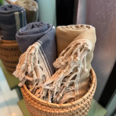 a basket filled with towels on a table at Private Room, 2 Minutes walk to KuDeTa Beach Seminyak in Seminyak