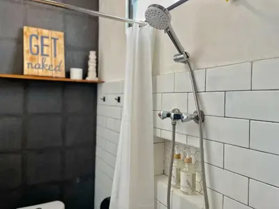 a shower in a bathroom with a shower curtain at Private Room, 2 Minutes walk to KuDeTa Beach Seminyak in Seminyak