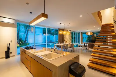 a large kitchen with a sink and a dining room at Villa Twin 1 by BaliSuperHost in Seminyak