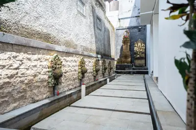 a walkway in front of a building with a shrine at Lumbung Sari Studio in Ngurah Rai International Airport
