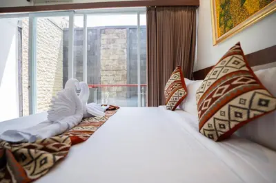 a bed in a room with a large window at Lumbung Sari Studio in Ngurah Rai International Airport