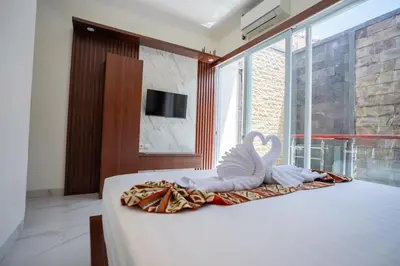 a white swan decoration sitting on top of a bed at Lumbung Sari Studio in Ngurah Rai International Airport