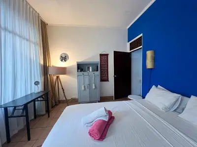a bedroom with a white bed with a pink towel on it at Digital Nomad Oasis in Bali Calm, Cozy, Connected in Kerobokan