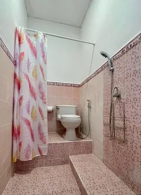 a bathroom with a toilet and a shower curtain at Digital Nomad Oasis in Bali Calm, Cozy, Connected in Kerobokan