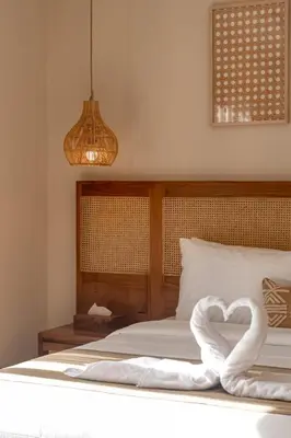 a bed with a heart shaped towel on it at A Better Villa 3BR Seminyak 5min Beach Bintang in Seminyak