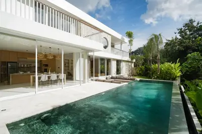 an exterior view of a house with a swimming pool at Villa Tiga by BaliSuperHost in Canggu