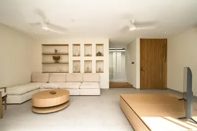 a living room with a white couch and a table at Villa Tiga by BaliSuperHost in Canggu