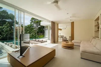 a living room with a couch and a table at Villa Tiga by BaliSuperHost in Canggu