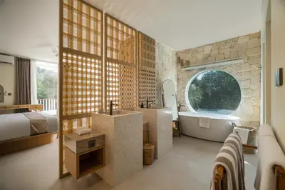 a bathroom with a large window and a tub and a bed at Villa Tiga by BaliSuperHost in Canggu