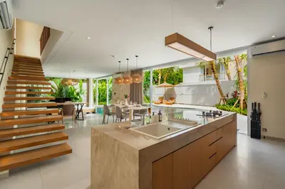a large kitchen with a staircase and a dining room at Villa Twin 2 by BaliSuperHost in Canggu