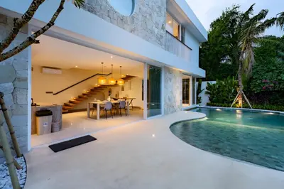 an external view of a house with a swimming pool at Villa Twin 2 by BaliSuperHost in Canggu
