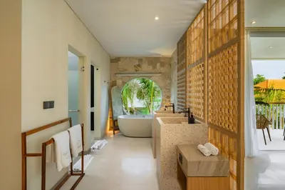 a bathroom with a bath tub and a sink at Villa Twin 2 by BaliSuperHost in Canggu