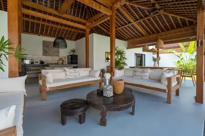 a living room with two couches and a table at Villa Nador Seminyak in Seminyak