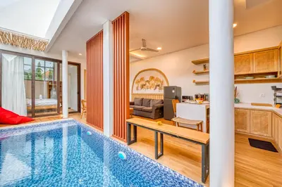 a house with a swimming pool and a living room at Affordable 2 Bedroom Villa in Kerobokan with Private Pool in Kerobokan