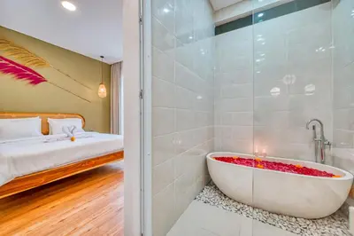 a bathroom with a tub next to a bedroom at Affordable 2 Bedroom Villa in Kerobokan with Private Pool in Kerobokan
