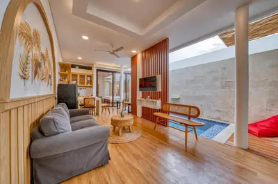 a living room with a couch and a table at Affordable 2 Bedroom Villa in Kerobokan with Private Pool in Kerobokan
