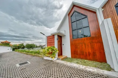 a house with a wooden door on a street at Affordable 2 Bedroom Villa in Kerobokan with Private Pool in Kerobokan