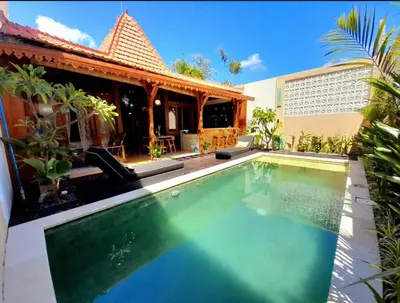 an image of a swimming pool in front of a house at Joglo Raera Bali by Allura in Seminyak