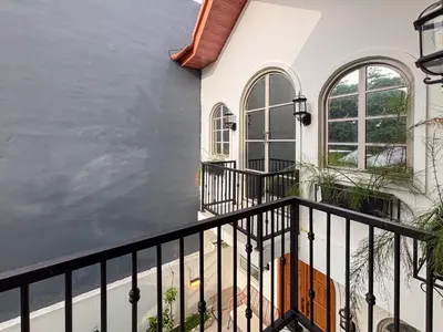 a white house with a black rail fence at The Lavana Villa Bungas near Nusa Dua in Jimbaran