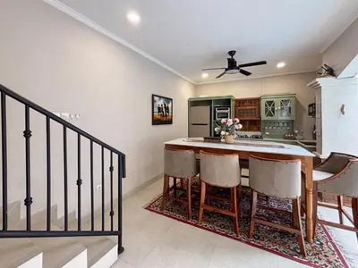 a kitchen with a table and chairs in a room at The Lavana Villa Bungas near Nusa Dua in Jimbaran
