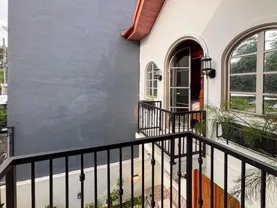 a house with a black railing on a balcony at The Lavana Villa Bungas near Nusa Dua in Jimbaran