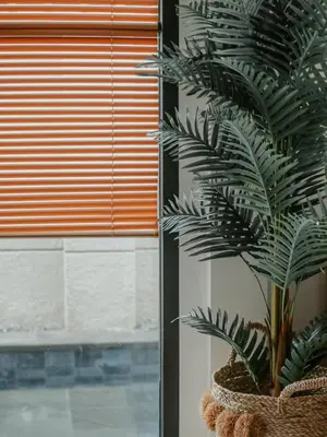 a plant in a basket next to a window at The Maru House in Seminyak