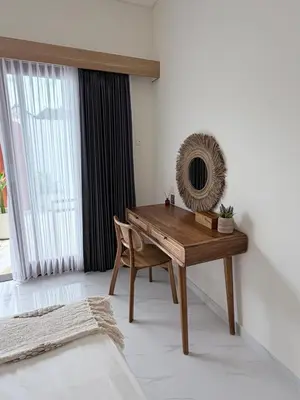 a desk in a room with a chair and a window at Villa Amore in Canggu