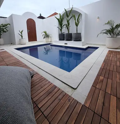 a swimming pool in the middle of a house at Villa Amore in Canggu