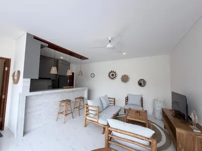 a living room with a couch and a table at Villa Amore in Canggu