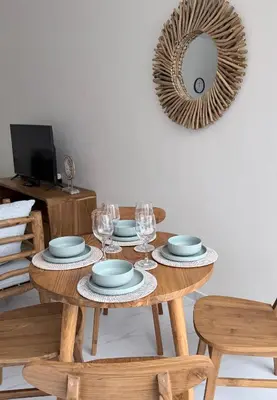 a table with plates and wine glasses and a mirror at Villa Amore in Canggu