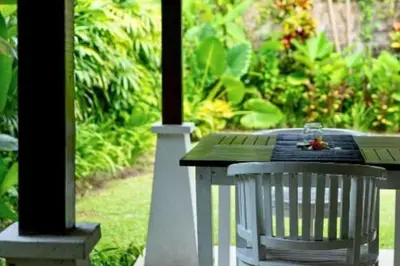 a table with a butterfly sitting on top of it at Calinda Tropical 1 BR Bungalow With Garden View in Seminyak