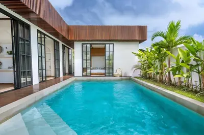 a swimming pool in the backyard of a villa at Palm Sugar Villa - Stylish 3BR Retreat with Pool in Jimbaran