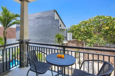 a patio with a table and chairs on a balcony at Ondio Villa in Seminyak