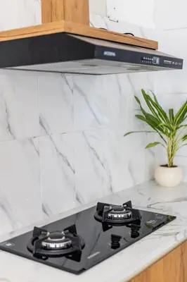 a black stove top oven sitting on top of a counter at Ondio Villa in Seminyak