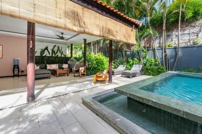 a swimming pool in a backyard with a villa at Indira Peaceful 1 BR Private Pool Villa in Seminyak