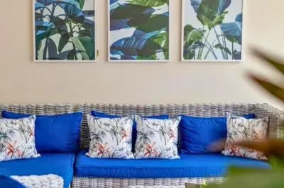 a blue couch with pillows in a living room at Gahyaka Comfortable 2 BR Deluxe Private Pool Villa in Seminyak